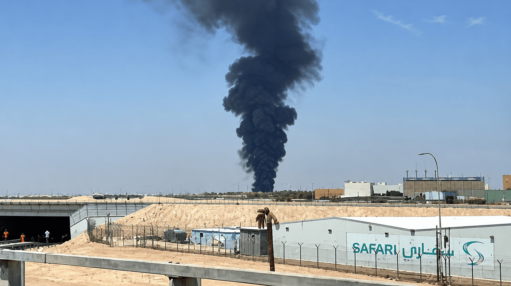 Industrial Skyline with Towering Smoke.png
